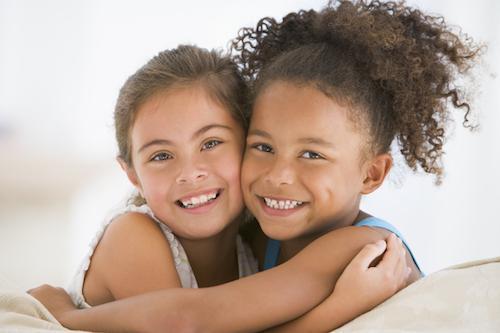 two young girls hugging 