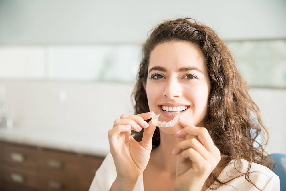 woman holding a night guard for bruxism