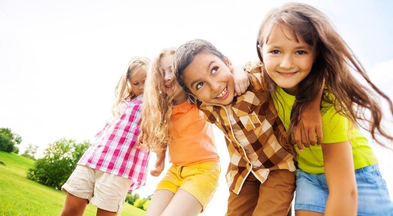 Four young kids smiling 